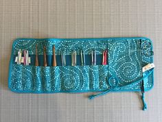 a blue case filled with different types of knitting needles