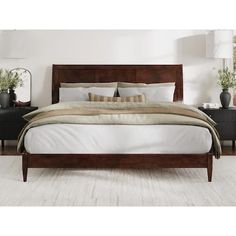 a large bed sitting in a bedroom next to two nightstands