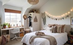 a white bed sitting under a window in a bedroom