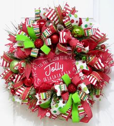 a red and green christmas wreath hanging on a door with the words jolly, i'm