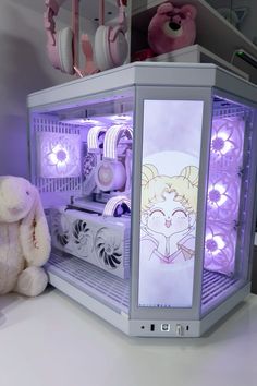 a white stuffed animal sitting next to a purple and white cabinet with electronic gadgets on it