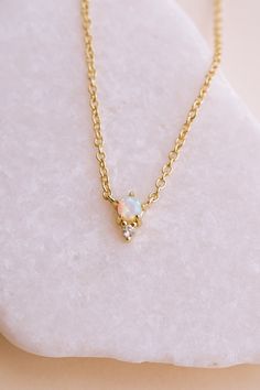 Our Odessa Opal Necklace is a piece you’ll fall in love with! Featuring a mesmerizing lab opal stone set in 14k gold-plated brass, this necklace adds a touch of elegance to any look. Whether you’re wearing it while running errands or for a glamorous night out, this versatile necklace is sure to become a new staple in your collection. Trust us - you'll be grabbing this one first from your jewelry box. NECKLACE FEATURES Material: Brass, Lab Opal Stone Dimensions/Size: 15.75" length + 2.25" extende