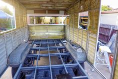 the inside of a storage container with metal bars and seats in place for people to sit on