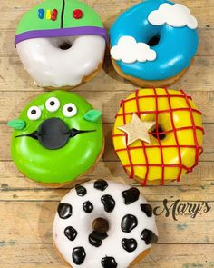 four donuts with different designs and colors on them