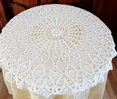 a white doily sitting on top of a wooden table