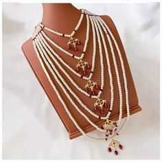 Elevate your ethnic ensemble with this stunning faux pearl and red stone mala necklace, adorned with intricate gold accents. Perfect for adding a touch of traditional elegance to any outfit, whether it's a festive celebration or a special occasion. Mala Necklace, Red Stone, Gold Accents, Faux Pearl, Special Occasion, Beaded Necklace, Jewelry Necklaces, Stone, Red