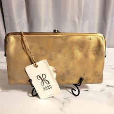 This Hobo 'Lauren' Limited Edition "Stardust" Wallet Is A Metallic Gold & Black Marble. It Features Their Iconic Antique Brass Hardware & Now Retired Wanderlust Lining. Made With Hobo's Signature Buttery Metallic Leather. It Has 2 Side Clasp Pouches To House All You Need; Phone, Keys, Extra Cards, 1 Zipper Pocket. Open It Up (Open/Closes With 2 Covered Magnets) & There's 3 Card Slots, An Id Window, & A Zipper Pouch That Runs The Width Of The Wallet, Perfect For Cash. Also Doubles As A Clutch. Ne Leather Coin Purse With Interior Card Slots For Evening, Evening Leather Coin Purse With Card Slots, Gold Leather Wallet For Evening, Gold Leather Evening Wallet, Evening Gold Leather Wallet, Rectangular Wallets With Gold-tone Hardware For Daily Use, Rectangular Wallet With Gold-tone Hardware For Daily Use, Everyday Gold Bags With Snap Closure, Gold Formal Bag With Interior Card Slots