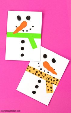 two snowmen made out of paper on a pink background