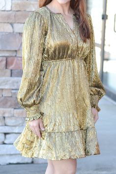 This metallic gold dress has long sleeves and an elastic waist with ruffle hem. Victoria is wearing the small. Fearless Dress, Metallic Gold Dress, Hair Accessories Jewelry, Gold Dress, Cardigan Jacket, Ruffle Hem, Metallic Gold, Bottoms Pants, Homecoming Dresses