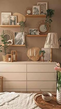 a white dresser topped with vases filled with flowers