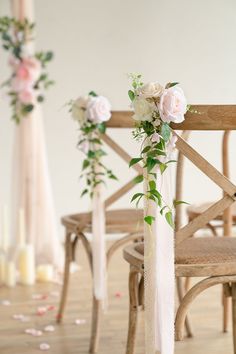 the chairs are decorated with flowers and greenery