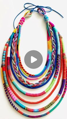 multicolored beaded necklace with blue cord on white background and text overlay