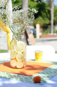 a mason jar filled with lemons and baby's breath