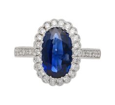 This vintage, retro, Art Deco-style ring features a GIA Certified 2.38-carat oval cut blue sapphire of Cambodian origin surrounded by 36 round-cut diamonds forming a tight halo,  weighing 0.39 carats total. All of these diamonds are set in an 18K white gold ring with stunning vintage a milgrain finish. Weighing 4.42 grams, this ring is a perfect blend of classic design and modern sophistication, ideal for those who appreciate the allure of vintage jewelry with a contemporary twist.  Item Details Oval Sapphire Ring Gia Certified, Blue Oval Gia Certified Halo Ring, Oval Brilliant Cut Sapphire Ring, Classic Blue Sapphire Ring With Oval Cabochon, Classic Blue Halo Ring, Classic Oval Sapphire Halo Ring, Gia Certified Blue Oval Rings, Luxury Blue Oval Halo Ring, Blue Oval Diamond Halo Ring