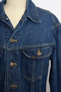 "A classic vintage 1970s Lee ride jean jacket. Super soft broken in darker indago denim. Metal button closure cropped style jacket with chest pockets and buttons at side waist. Label: Lee Sanforized Patd: 153438 Fits like size: Medium/Small- See measurements to be sure. Measurements: Chest: 40\" Waist: 34\" Length: 21\" Shoulder to shoulder: 19\" Sleeve length: 25\" Condition: Very good vintage condition. Perfectly broken in with no flaws aside form minor fade, mostly at neck crease. Please do n Riding Jeans, Levis Denim Jacket, Lee Jeans, Cropped Style, Metal Buttons, Classic Vintage, Jean Shirts, Vintage 1970s, Full Skirt