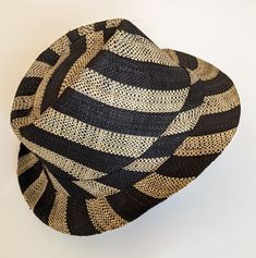 Lightweight fedora sun hat that is very comfortable to wear. Good protection from sun. Breathable light design.  Our fun striped hat will add style and chic to your summer outfit! Very flattering unisex design - will surely stand out wherever you wear it - beach, party, everyday use.  Made in Madagascar. Striped Bucket Sun Hat For Beach, Striped Bucket Hat For Beach, Striped Summer Hats For Vacation, Summer Beach Hat With Stripes, Striped Bucket Hat For The Beach, Summer Striped Vacation Hat, Summer Vacation Striped Hat, Adjustable Striped Straw Hat For Vacation, Striped Brimmed Sun Hat For Beach