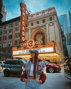 a woman standing in front of the chicago theater