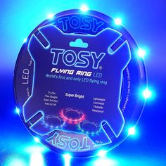 a blue lighted plate with the words tosy playing ring on it's side