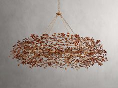 a chandelier hanging from a chain with leaves