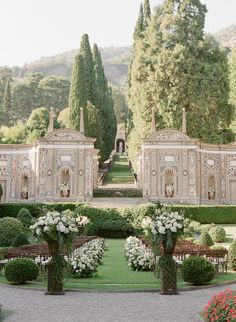 an outdoor wedding venue with white flowers and greenery