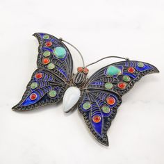 "More Unique Sterling Silver Brooches: https://www.etsy.com/shop/SilverStarrs925?section_id=15203699 Beautiful  Silver Brooch This brooch is 2 1/8\" inches long It is 3 1/4\" inches wide The brooch weighs 18.4 Grams The stone or design featured on this brooch is Enamel, Turquoise Butterfly  The color of the stone or design is Blue, Red, White, Green, Orange Markings, if any are: C1992, MMA, Cleo, Ag, (Tested & Guaranteed to be Sterling Silver) The condition of this brooch is Very good, the patin Multicolor Enamel Brooch Jewelry, Silver Cabochon Brooches For Jewelry Making, Silver Bohemian Brooches For Collectors, Silver Bohemian Brooch Jewelry, Silver Bohemian Jewelry Brooch, Multicolor Butterfly Brooch Jewelry, Silver Multi-stone Brooches, Turquoise Cabochon Brooch As A Gift, Turquoise Cabochon Brooch For Gift