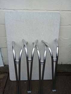 four metal handles on the side of a wall