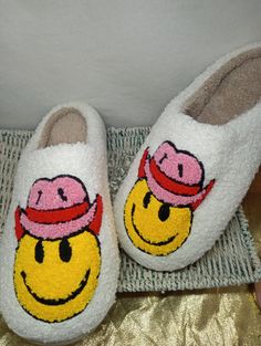 Stay cozy and put a smile on your face with these Smiley Face House Slippers! These slippers will keep your feet warm and provide you with hours of comfort. Slip them on and have fun! Get ready to embrace the joy of a smiley face. Cute Round Toe Slippers For Leisure, Cute Round Toe Slippers For Loungewear, Playful Winter Slip-on Slippers, Fun White Slip-on Slippers, Cute White Slippers For Leisure, Winter Lounging Slippers With Round Toe, Cozy Winter Slippers For Leisure, White Casual Slippers, Casual White Slippers For Home