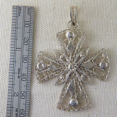 This Sterling Silver Ornate Cross is stamped 925. The elaborate filigree draws attention to this unique cross. This pendant does not come with a chain. If you would like a chain please contact me and I'll be happy to find you a new or estate chain that suits your needs. Total Weight: 6.5g These pieces are pre-owned vintage jewelry. As this jewelry is not new there may be signs of wear or age. Each piece is sold as-is unless otherwise specified (ex. sizing). We strive to only sell vintage jewelry Ornate Silver Cross Jewelry, Silver Filigree Cross Jewelry, Traditional Filigree Cross Jewelry, Antique Silver Symbolic Cross Jewelry, Ornate Silver Cross Pendant Necklace, Ornate Cross, Find You, Vintage Jewelry, Finding Yourself