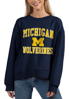 Make your way to the big game in this Michigan WolverinesWomens Navy Blue Old School Crew Sweatshirt! This Wolverines Long Sleeve Sweatshirt features a screen print team name and logo on center chest. Stay warm and comfortable with this Womens Michigan Wolverines Crew Sweatshirt. Long sleeve, Crew neck, Finished hem, High low bottom hem, 60% COTTON / 40% POLYESTER, 4 Sporty Tops For Campus During Sports Season, Collegiate Tops With University Logo For Game Day, Letter Print Sweatshirt For Campus, College Style Sports Tops With Team Name, Collegiate Fan Gear Tops For Winter, Varsity Crew Top For Fan Gear, Collegiate Crew Neck Top For Campus, Collegiate Winter Tops For Fan Gear, Collegiate Style Winter Fan Gear Tops