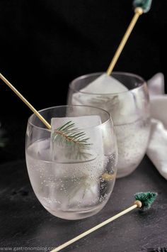 two glasses filled with ice and some toothpicks