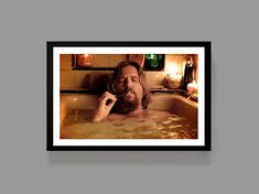 a man with long hair and beard in a bathtub talking on a cell phone