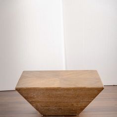 a wooden object sitting on top of a hard wood floor