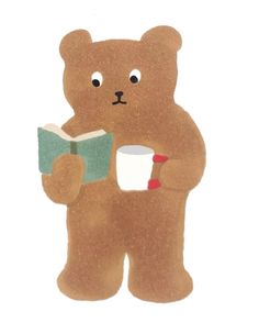 a brown teddy bear holding a book and cup