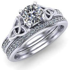 a white gold wedding ring set with an intricate design and diamond accents on the band