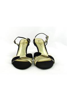 Style these strappy gold & black sandals with any evening dress. Made with a small heel, you will be able to dance the night away in these fabulous shoes. Size 7.5 B Leather & fabric upper Leather sole Gold-tone buckle Strappy style Open toe Light outsole wear Mark on interior lining Heel height 3.5" Gold Closed Toe Sandals For Gala, Fitted Low Heel Sandals For Prom, Gold Sandals With 4-inch Heel For Prom, Elegant Open Heel Sandals For Holiday, Strappy Evening Sandals, Black Heels For Formal Holiday Occasions, Party Heels With Removable Insole And Low Heel, Evening Sandals With 4-inch Heel, Fitted Low Heel Sandals For Events