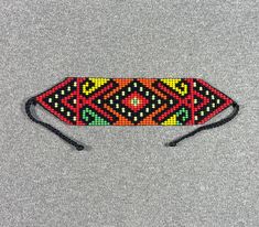 This beautiful beaded necklace is hand-woven by the women of the Embera Chami Indigenous Tribe of Colombia Bohemian Rectangular Beaded Necklaces For Festivals, Traditional Handwoven Jewelry, Traditional Handwoven Rectangular Jewelry, Bohemian Rectangular Beaded Necklace, Traditional Adjustable Rectangular Necklaces, Bohemian Rectangular Beaded Necklaces, Traditional Adjustable Rectangular Necklace, Multicolor Rectangular Beaded Necklace For Festivals, Traditional Adjustable Beaded Choker