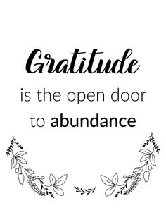 a quote that says,'gratitude is the open door to abundance'in black and white