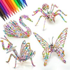 four different types of paper butterflies with colored pencils in the background