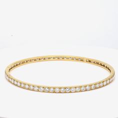 Title: 9.75 Carat Diamond 18 Karat Yellow Gold Bangle Bracelet Style: Bangle Metal: 18 Karat Yellow Gold Gemstone 1: 9.75 Carat Diamond Number of Stones: 65 Color: G Clarity: VS1 Shape: Round Brilliant Dimension: 7-3/4in X 3.5mm Weight: 11.8 Grams Condition: Vintage And Estate Product ID: R21J58 Note: Please note that all the non-GIA Gemstones' Weight, Color, Cut, and Clarity are estimated values to the best of our knowledge. Formal Single Cut Diamond Bangle, Luxury White Gold Bracelet Channel Set, Luxury White Gold Bracelets Channel Set, Luxury White Gold Channel Set Bracelets, Luxury Tennis Bracelet With Channel Set For Formal Occasions, Classic Channel Set Bracelet For Formal Occasions, Luxury Channel Set Tennis Bracelet For Formal Occasions, Formal Hand Set Yellow Gold Bangle, Formal Classic Gold Bracelet With Single Cut Diamonds