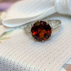 Brazilian Red Citrine Solitaire Ring With White Zircon* Accent Stones. Set In Platinum Over .925 Sterling Silver. Tgw 3.85 Carats. The Citrine Stone Is 10mm. Ring Is Size 7. Comes New In Box For Safekeeping And Gift Giving. Nwt *Zircon Is A Natural Gemstone Mined From The Earth And Not To Be Confused With The Man Made “Cz” Or Cubic Zirconia Elegant Red Gemstone With Center Stone, Sterling Silver Ruby Ring With Accent Stones, Classic Red Gemstones With Center Stone, Formal Red Birthstone Ring With Prong Setting, Red Sterling Silver Jewelry With Center Stone, Red Sterling Silver Rings With Prong Setting, Elegant Sterling Silver Solitaire Gemstone, Red Gemstones With Center Stone For Gift, Elegant Solitaire Sterling Silver Gemstone