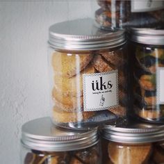 several glass jars filled with different types of cookies