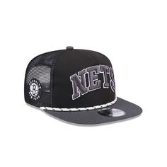 Stay shaded in classic style with this Brooklyn Nets Throwback Team Arch snapback hat from New Era. It features a team wordmark across the front and logo on the side. The mesh panels and rope across the visor add dashing details to this Brooklyn Nets hat.Stay shaded in classic style with this Brooklyn Nets Throwback Team Arch snapback hat from New Era. It features a team wordmark across the front and logo on the side. The mesh panels and rope across the visor add dashing details to this Brooklyn Collegiate Adjustable Snapback Trucker Hat, Collegiate Streetwear Trucker Hat With Curved Brim, Collegiate Trucker Hat With Curved Brim For Streetwear, Collegiate Style Trucker Hat With Curved Brim For Streetwear, Collegiate Snapback Trucker Hat With Embroidered Logo, Collegiate Trucker Hat With Embroidered Logo And Flat Brim, Sporty Flat Brim Trucker Hat For Fan Merchandise, Collegiate Flat Bill Trucker Hat For Streetwear, Throwback Snapback Trucker Hat For Baseball Season