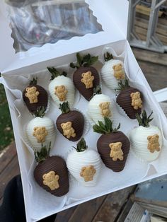 chocolate covered strawberries with teddy bears on them in a white cardboard box, ready to be eaten