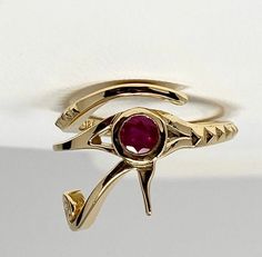 18K gold and Ruby Eye of Ra ring Make a bold statement with this ring that features the eye of Ra a protective symbol said to destroy evil around the wearer in ancient Egyptian culture. Ruby Round Natural Eye-clear Message for pricing in other karats or gemstone customization. Masonic Eye, Egyptian Ring, The Eye Of Ra, Peacock Ring, Ancient Egyptian Symbols, Mens Skull Rings, Eye Of Ra, Oxidized Silver Rings, Lace Ring