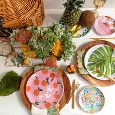 the table is set with colorful plates and place settings