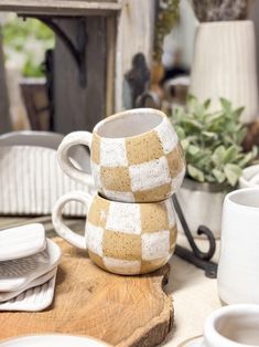 two coffee cups are stacked on top of each other in the middle of a table