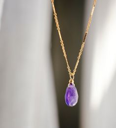 Indulge in the energy of Amethyst with this dainty necklace! Handcrafted with genuine deep purple Amethyst in a faceted teardrop shape, this crystal pendant comes on your choice of a sterling silver or 14k gold filled chain in various styles. It's perfect as bridesmaid gifts, for those born in February, or a special treat for yourself. Amethyst Meaning: Amethyst is believed to enhance passion, creativity, and spirituality. It's also said to assist with temperance and sobriety, as well as inflamm Teardrop Amethyst Jewelry With Faceted Detail, Faceted Teardrop Amethyst Jewelry, Teardrop Faceted Amethyst Jewelry, Gold Amethyst Crystal Necklace, Faceted, Faceted Lavender Teardrop Jewelry, Minimalist Teardrop Crystal Necklaces For Jewelry Making, Purple Faceted Crystal Necklaces For Gifts, Spiritual Teardrop Faceted Necklace, Lavender Amethyst Teardrop Necklace