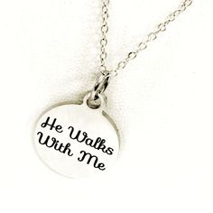 "This motivating necklace would make a great gift to remind a Christian woman in your life that God is with her. The pendant is a stainless steel laser engraved pendant with \"He Walks With Me\" on it. The pendant comes on a silver-plated link chain. This pendant is available on your choice of 16, 18, 20, 22, 24, 26, 28 or 30 inch chain. The pendant is also available for individual purchase if you have another chain on which you would like to wear it. This jewelry item has small parts and is not Personalized Laser Engraved Stainless Steel Jewelry, Hypoallergenic Stainless Steel Necklace For Anniversary, Mother's Day Stainless Steel Laser Engraved Jewelry, Meaningful Stainless Steel Necklaces For Anniversary, Inspirational Nickel-free Stainless Steel Jewelry, Meaningful Stainless Steel Jewelry For Best Friend, Engraved Stainless Steel Charm Necklaces For Mom, Meaningful Stainless Steel Necklace As Gift, Engraved Stainless Steel Charm Necklace For Mom