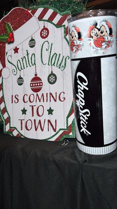 there is a christmas sign next to a soda can