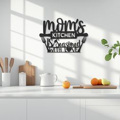 a kitchen counter with some fruit on it and a metal sign that says mom's kitchen is seasoned with love